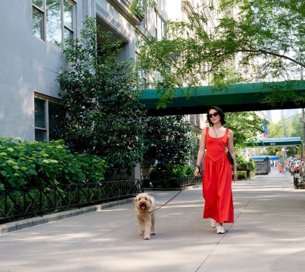 Women in red dress walking dog in the upper east side