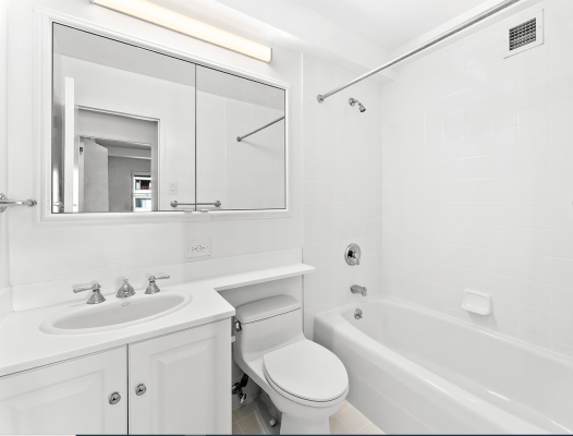a clean white bathroom in an NYC apartment rental