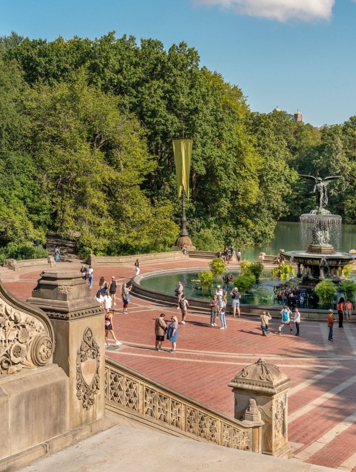Looking down onto a fountain in Central Park from stairs on a sunny day