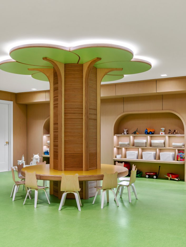 Childrens play room with tree table and small chairs around it